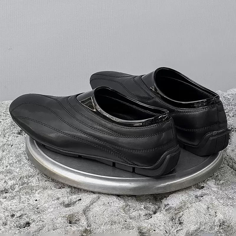 STUDIO slip-on trainer in black, pair on a steel disc